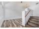 Bright living room with wood-look floors, staircase, and a large window showcasing natural light at 8037 W Mohave St, Phoenix, AZ 85043
