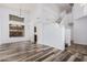 Open-concept living room with tall ceilings, wood-look floors, and stairs leading to the second floor at 8037 W Mohave St, Phoenix, AZ 85043
