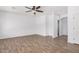 Spacious bedroom with wood-look floors, neutral paint, and a ceiling fan at 8037 W Mohave St, Phoenix, AZ 85043