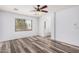 Spacious main bedroom with wood-look floors, ceiling fan, and ensuite bath access at 8037 W Mohave St, Phoenix, AZ 85043