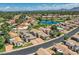 Beautiful neighborhood aerial view showcasing mature landscaping, a lake, and well-maintained homes at 8136 E Cortez Dr, Scottsdale, AZ 85260