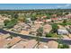 This aerial shows stunning homes with well-kept lawns, mature trees, and gorgeous desert views at 8136 E Cortez Dr, Scottsdale, AZ 85260