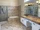 Bathroom features a double sink vanity, bathtub, and a separate shower enclosure at 8136 E Cortez Dr, Scottsdale, AZ 85260