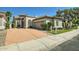 Desert home boasts a xeriscaped front yard and driveway, set against a backdrop of blue skies at 8136 E Cortez Dr, Scottsdale, AZ 85260
