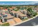 Stunning aerial view of a desert home featuring a tile roof, lush landscaping, and a picturesque lake at 8136 E Cortez Dr, Scottsdale, AZ 85260