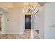 Inviting home foyer with tile flooring, high ceilings, and an elegant chandelier at 8136 E Cortez Dr, Scottsdale, AZ 85260