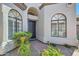 Stylish front entrance framed by arched windows and lush desert landscaping at 8136 E Cortez Dr, Scottsdale, AZ 85260