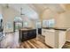 Gourmet kitchen with granite counters, dark cabinetry and open layout to dining at 8136 E Cortez Dr, Scottsdale, AZ 85260