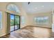 Bright living room features wood floors, high ceilings, and sliding glass doors to a patio at 8136 E Cortez Dr, Scottsdale, AZ 85260
