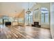Open concept living space features soaring ceilings, a fireplace, and wood-style floors at 8136 E Cortez Dr, Scottsdale, AZ 85260