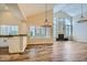 This airy living room showcases wood-style floors, fireplace, and seamless flow to the kitchen at 8136 E Cortez Dr, Scottsdale, AZ 85260