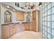 Light and bright bathroom with dual vanities, and plenty of storage in the wood cabinets at 8514 E Country Club Trl, Scottsdale, AZ 85255