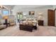 Inviting bedroom with a wrought iron bed frame, an upholstered bench, and a door to an outdoor balcony at 8514 E Country Club Trl, Scottsdale, AZ 85255