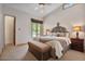Charming bedroom featuring an ornate headboard, ceiling fan, and windows that let in plenty of light at 8514 E Country Club Trl, Scottsdale, AZ 85255