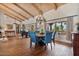 Open dining room with hardwood floors, large windows, and stylish chandelier at 8514 E Country Club Trl, Scottsdale, AZ 85255