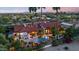 Expansive home exterior features a private pool, lush landscaping, and a red tile roof at 8514 E Country Club Trl, Scottsdale, AZ 85255