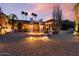 Elegant front entrance with custom iron gate, stone accents, and well-manicured desert landscaping at 8514 E Country Club Trl, Scottsdale, AZ 85255