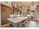 Elegant kitchen with granite countertops, custom cabinetry, and breakfast bar seating at 8514 E Country Club Trl, Scottsdale, AZ 85255