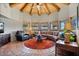 Unique living room with a round design, wood ceiling, and curved leather sectional at 8514 E Country Club Trl, Scottsdale, AZ 85255