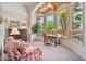 Bright living room features large windows with views, a ceiling fan, and comfortable seating arrangements at 8514 E Country Club Trl, Scottsdale, AZ 85255