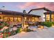 Inviting covered outdoor patio with comfortable seating, dining area, and beautiful garden views at 8514 E Country Club Trl, Scottsdale, AZ 85255