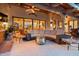 Inviting covered patio with plush seating, a modern coffee table, and warm lighting at 8514 E Country Club Trl, Scottsdale, AZ 85255
