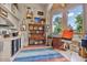 Bright studio space featuring ample natural light, a colorful rug, and an artistic setup at 8514 E Country Club Trl, Scottsdale, AZ 85255