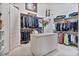 Well-organized walk-in closet with custom shelving, drawers, and ample storage space for clothing at 8514 E Country Club Trl, Scottsdale, AZ 85255