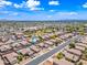 Expansive aerial view of a desert neighborhood with a community park and meticulously maintained desert landscaping at 8657 E Capri Ave, Mesa, AZ 85208