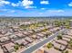 Expansive aerial view of a desert neighborhood with a community park and meticulously maintained desert landscaping at 8657 E Capri Ave, Mesa, AZ 85208