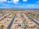 High aerial view showcasing a desert community with a perimeter wall, and mountain views in the distance at 8657 E Capri Ave, Mesa, AZ 85208