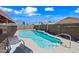 Well-maintained pool with a sun lounger, set in a private backyard with lush landscaping at 8657 E Capri Ave, Mesa, AZ 85208
