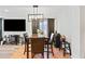 Dining room with modern chandelier, rustic table, and adjacent living area at 8657 E Capri Ave, Mesa, AZ 85208