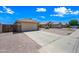 Street view of a single story home with a 2 car garage, neutral colored gravel yard and light colored driveway at 8657 E Capri Ave, Mesa, AZ 85208
