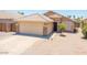 Charming single-story home featuring a well-maintained yard, two-car garage, and neutral color palette at 8657 E Capri Ave, Mesa, AZ 85208
