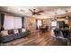 Cozy living room with stylish furnishings and hardwood-style flooring, flowing into the kitchen at 8657 E Capri Ave, Mesa, AZ 85208