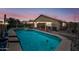Stunning pool at dusk, complete with a covered patio and outdoor seating area at 8657 E Capri Ave, Mesa, AZ 85208