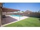 Backyard featuring a private pool, covered patio, and artificial turf for easy maintenance and relaxation at 8657 E Capri Ave, Mesa, AZ 85208