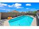 Sparkling backyard pool on a sunny day, surrounded by well-maintained landscaping and privacy fencing at 8657 E Capri Ave, Mesa, AZ 85208