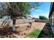 Large backyard with mature tree, block fence, and outdoor grill at 9026 W Cambridge Ave, Phoenix, AZ 85037