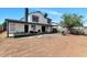 Spacious backyard showcasing a two-story home, covered patio, and outdoor grill at 9026 W Cambridge Ave, Phoenix, AZ 85037