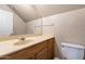 Bathroom with neutral countertops, wood cabinets, toilet and large mirror at 9026 W Cambridge Ave, Phoenix, AZ 85037