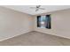 Bedroom with neutral paint, carpeting, fan, and window with view at 9026 W Cambridge Ave, Phoenix, AZ 85037