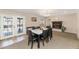 Elegant dining room with a modern table, fireplace, and doors leading to patio at 9026 W Cambridge Ave, Phoenix, AZ 85037