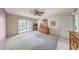Comfortable bedroom featuring a ceiling fan and large windows fitted with plantation shutters at 9512 W Mcrae Way, Peoria, AZ 85382