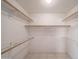 Well-organized walk-in closet with multiple wooden rods and shelving units at 9512 W Mcrae Way, Peoria, AZ 85382