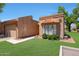 Inviting front exterior showcasing a well-manicured lawn, desert landscaping, and a tile roof at 9512 W Mcrae Way, Peoria, AZ 85382