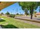 Community street view showcasing lush trees and landscaped grounds, enhancing the neighborhood's curb appeal at 9512 W Mcrae Way, Peoria, AZ 85382