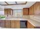 Functional kitchen with wooden cabinets, good counter space, and ample natural light at 9512 W Mcrae Way, Peoria, AZ 85382