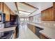 Charming kitchen featuring wooden cabinets and a view to the dining area at 9512 W Mcrae Way, Peoria, AZ 85382